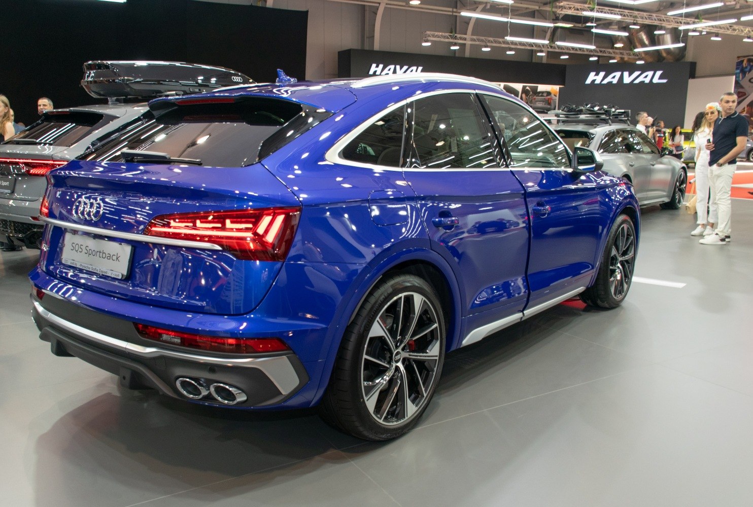 Rear side view of blue SUV with LED lights and quad exhausts