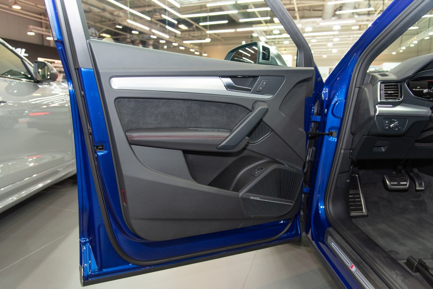 Interior door panel with speaker grille and controls