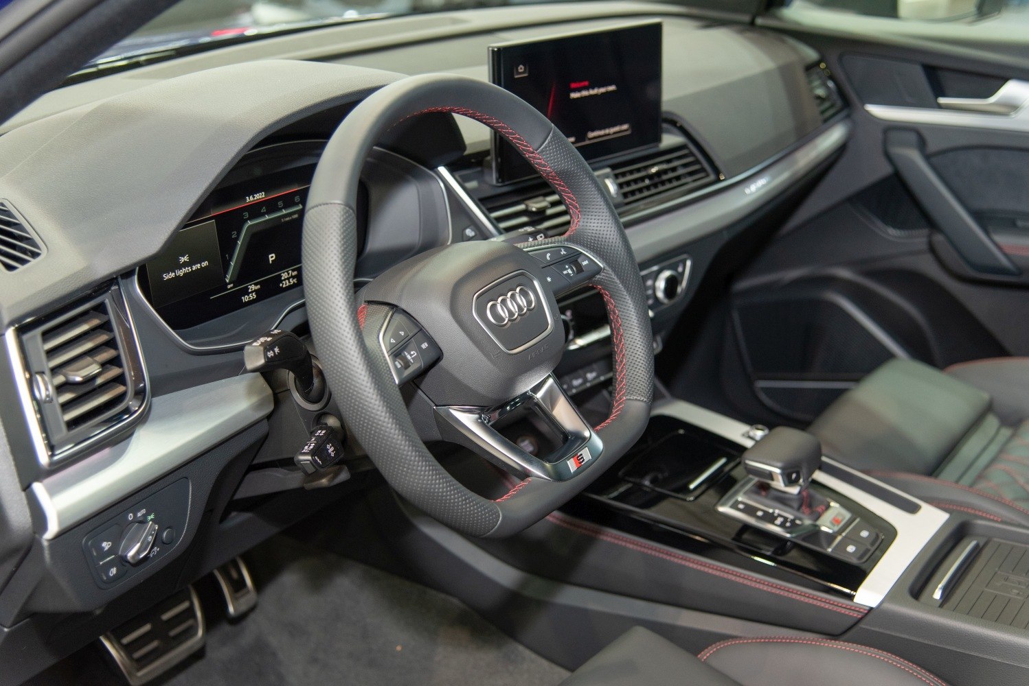 Sporty steering wheel and digital dashboard with modern center console