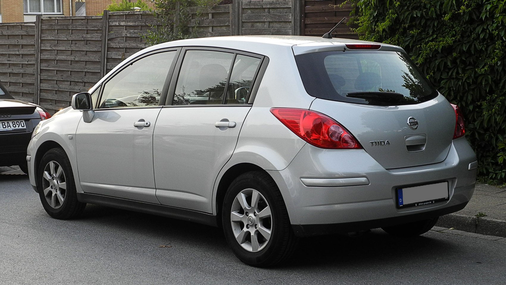 Silver hatchback rear side with distinct tail lights and window design