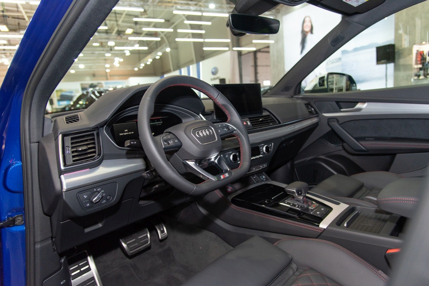 Sporty steering wheel and modern infotainment display in luxury SUV interior