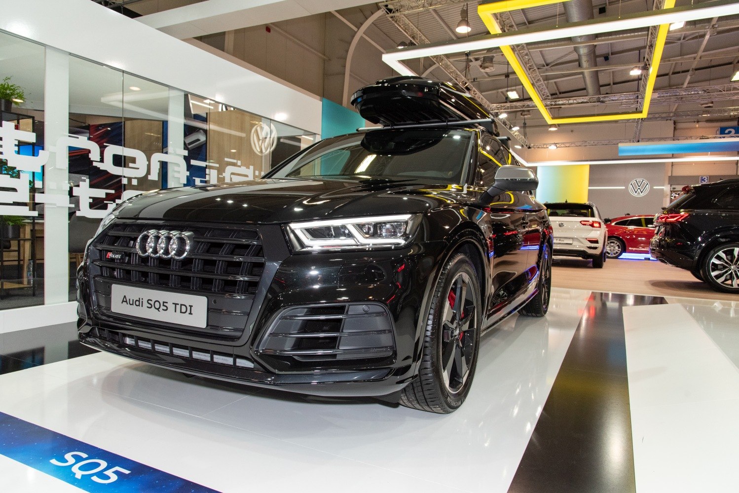 Close-up of Audi SQ5 front grille and LED headlights in showroom