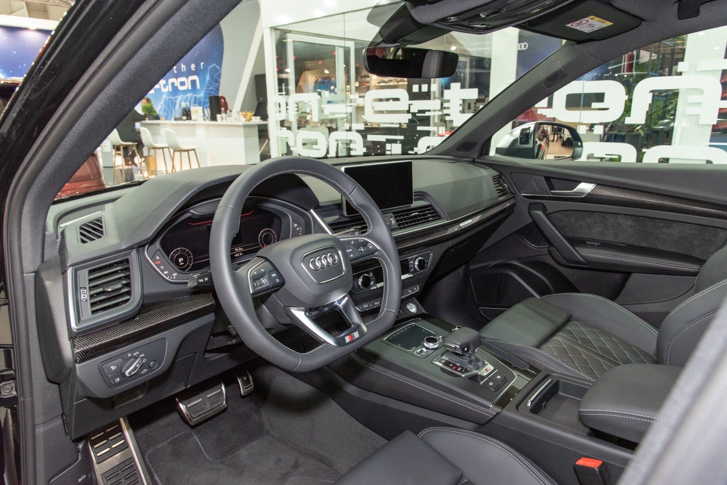 Luxury car interior with dashboard, steering wheel, and center console