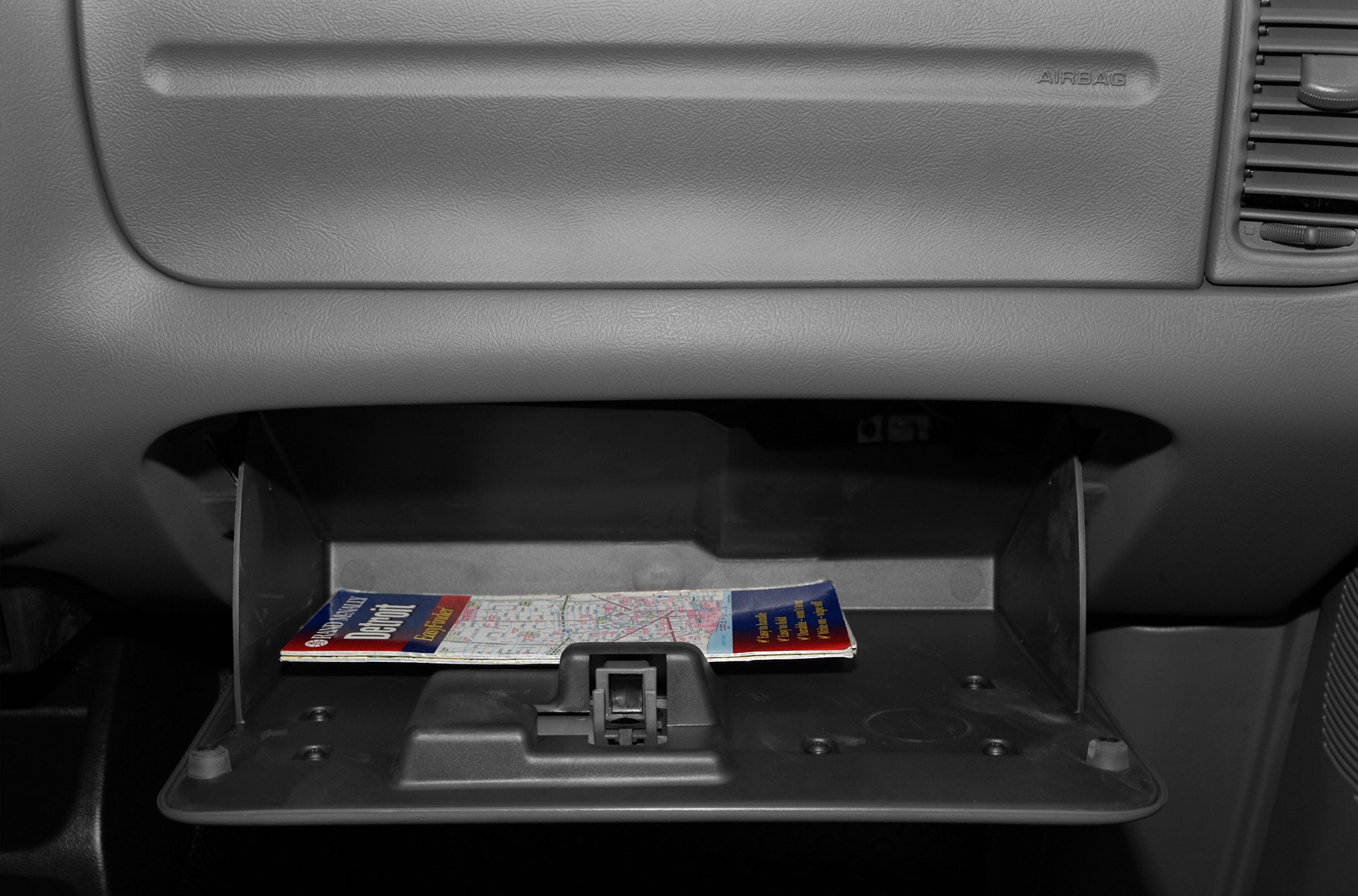 Open glove compartment with map inside