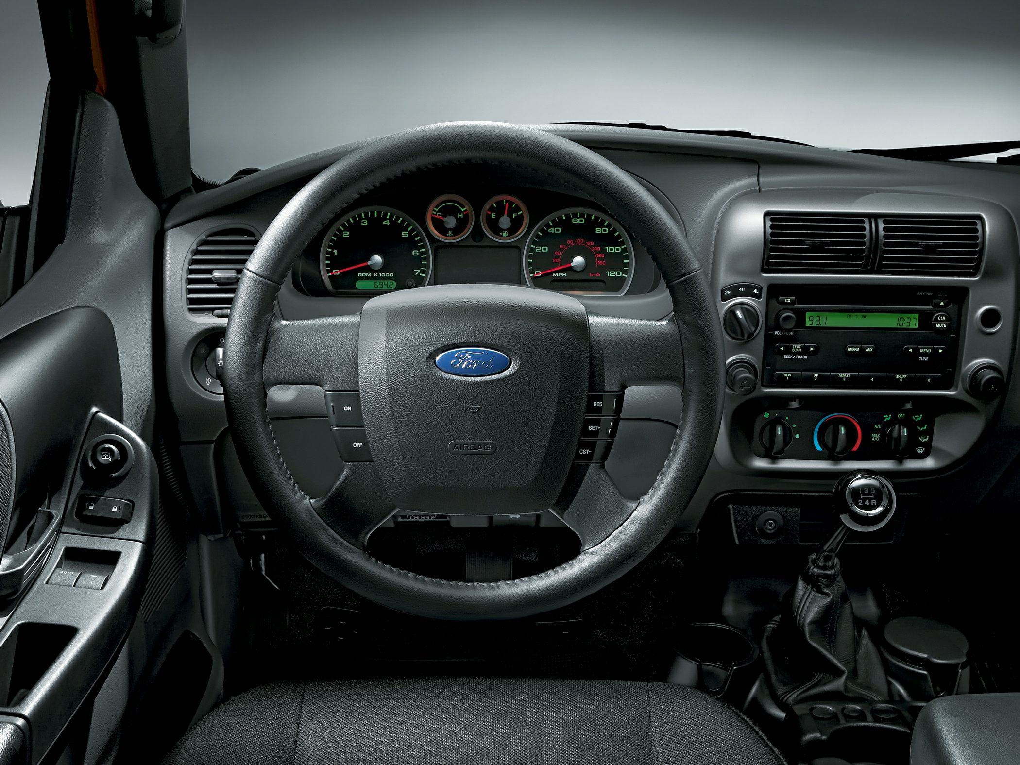 Steering wheel, dashboard, manual gear shift, and control panel inside vehicle