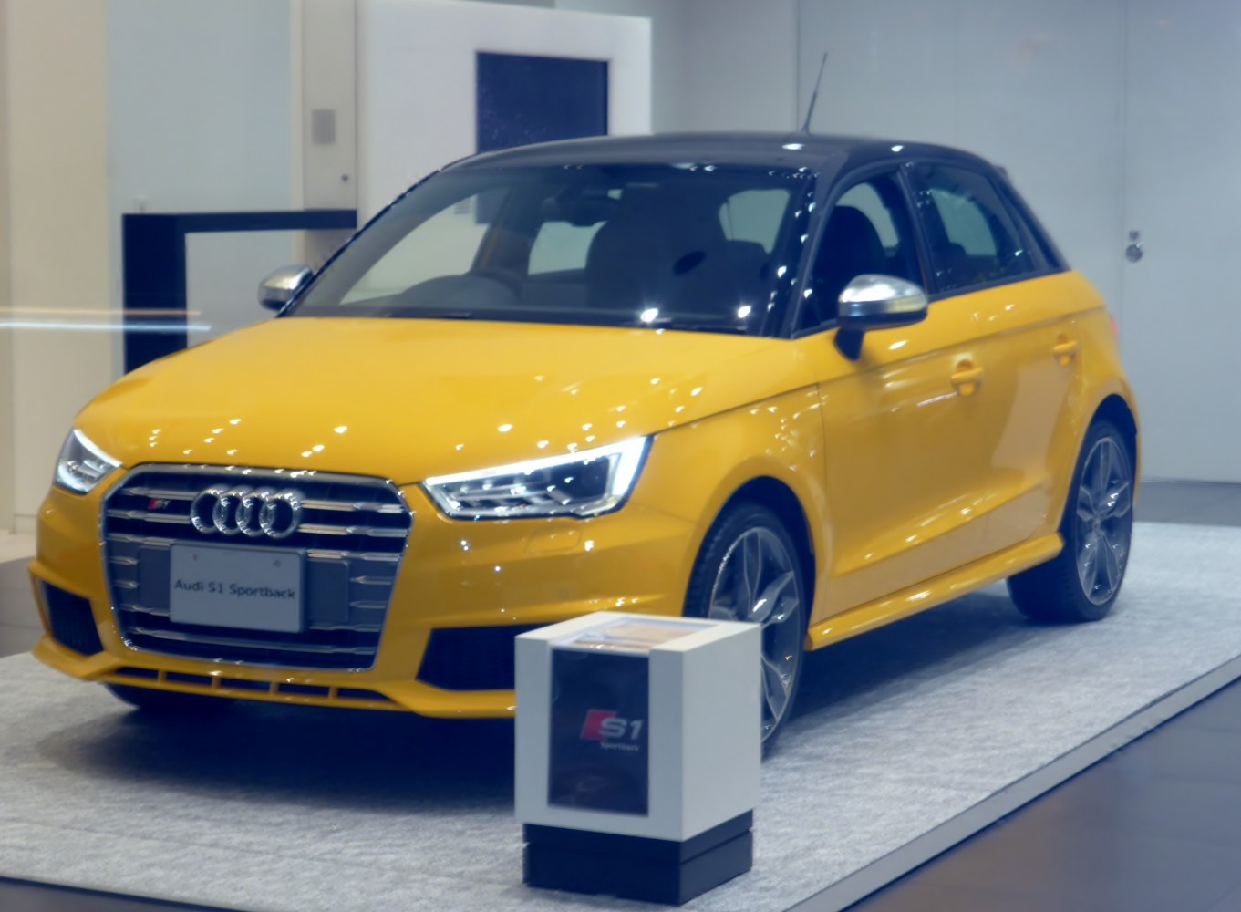 Yellow hatchback with black roof and sporty front design