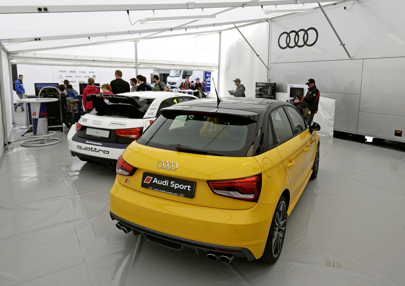 Rear view showing quad exhaust and sporty hatchback design