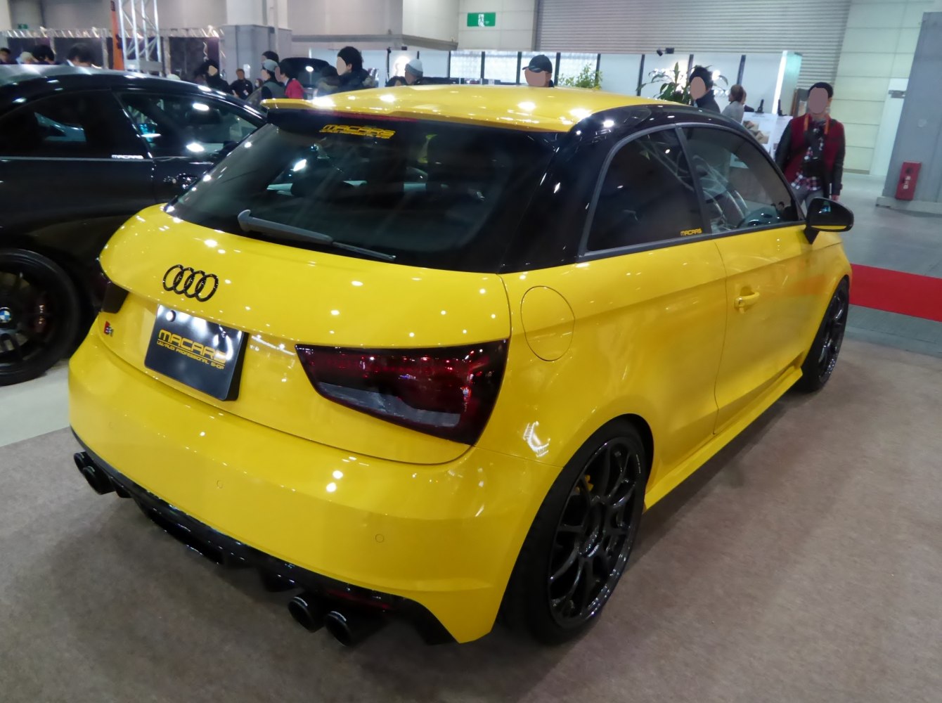 Yellow hatchback with black roof and quad exhaust