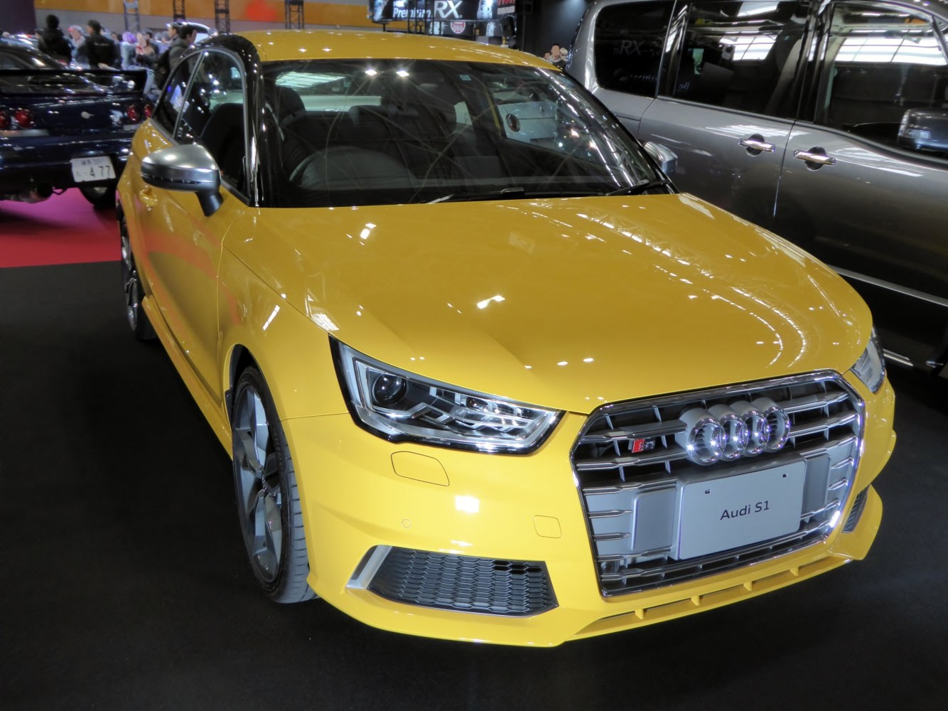 Yellow sporty hatchback with distinctive grille and LED headlights