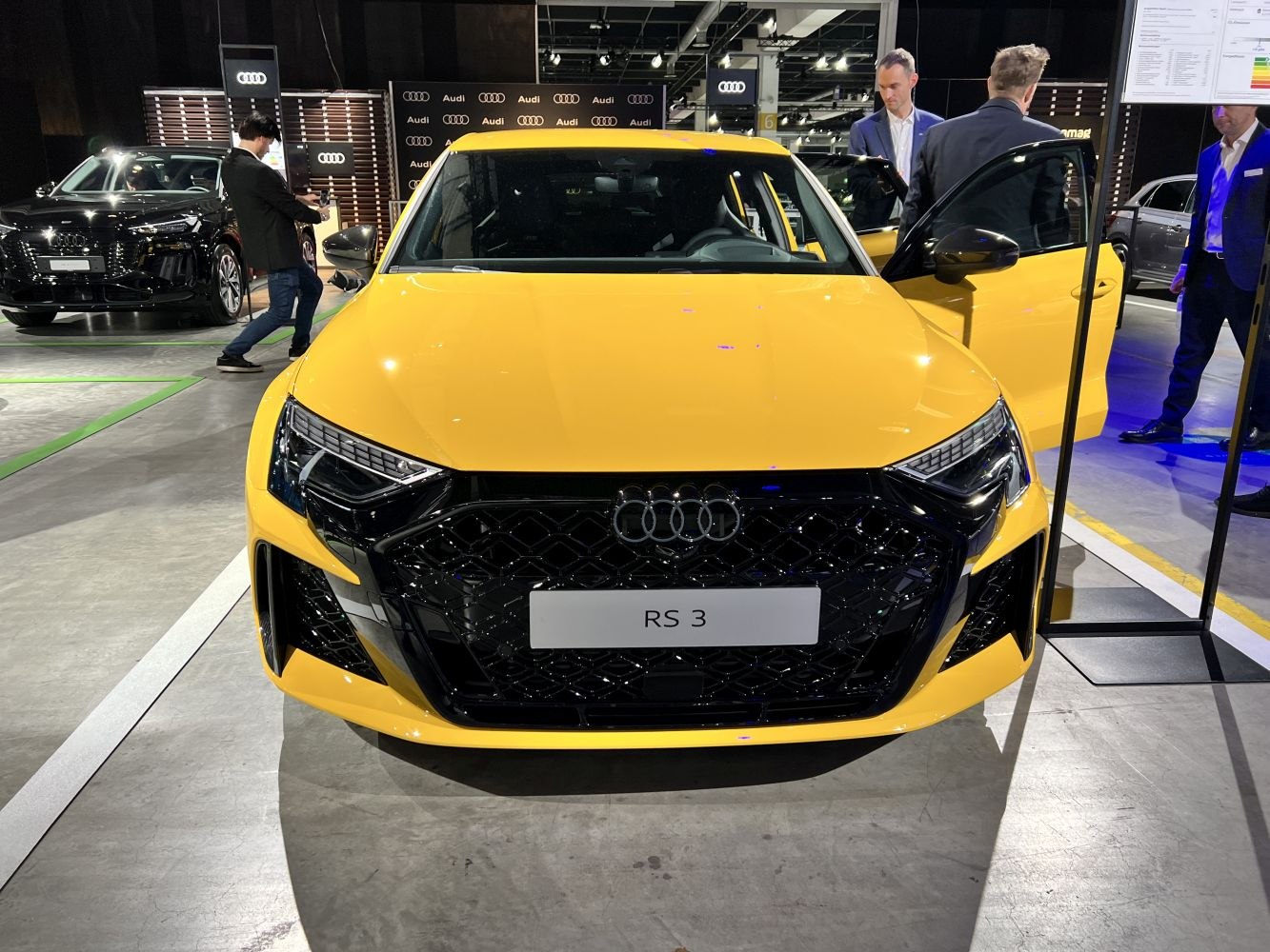 Aggressive front grille and sharp LED headlights of yellow sporty hatchback