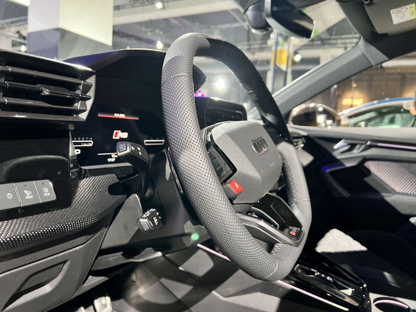 Audi RS 3 steering wheel and digital dashboard interior.