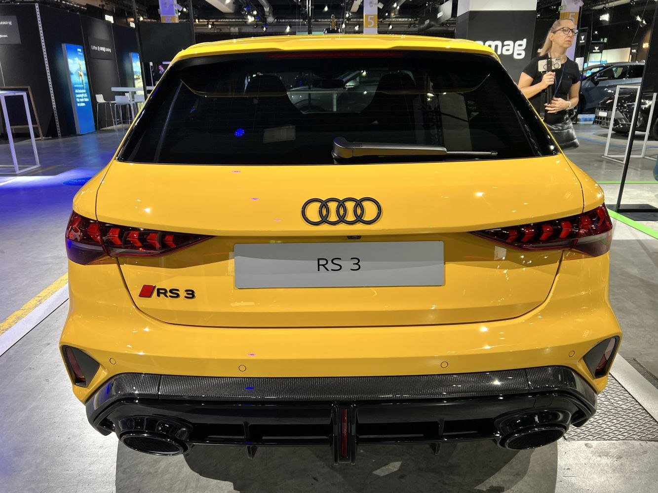 Yellow hatchback rear with distinctive LED taillights and dual exhausts