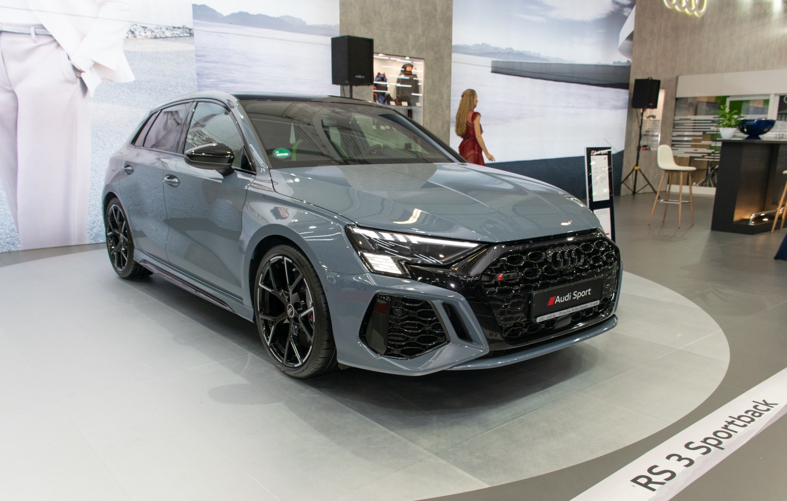 Front side view of sporty hatchback with honeycomb grille and black alloy wheels