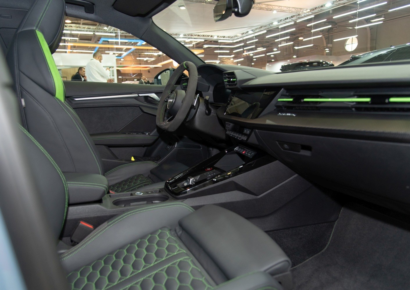Sporty car interior with green stitching and digital dashboard