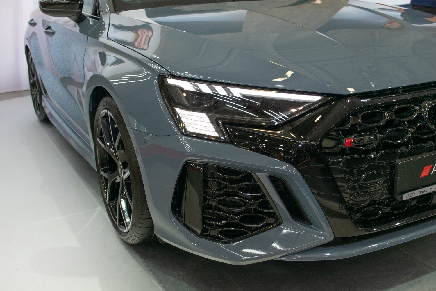 Close-up of aggressive LED headlights and honeycomb grille front end