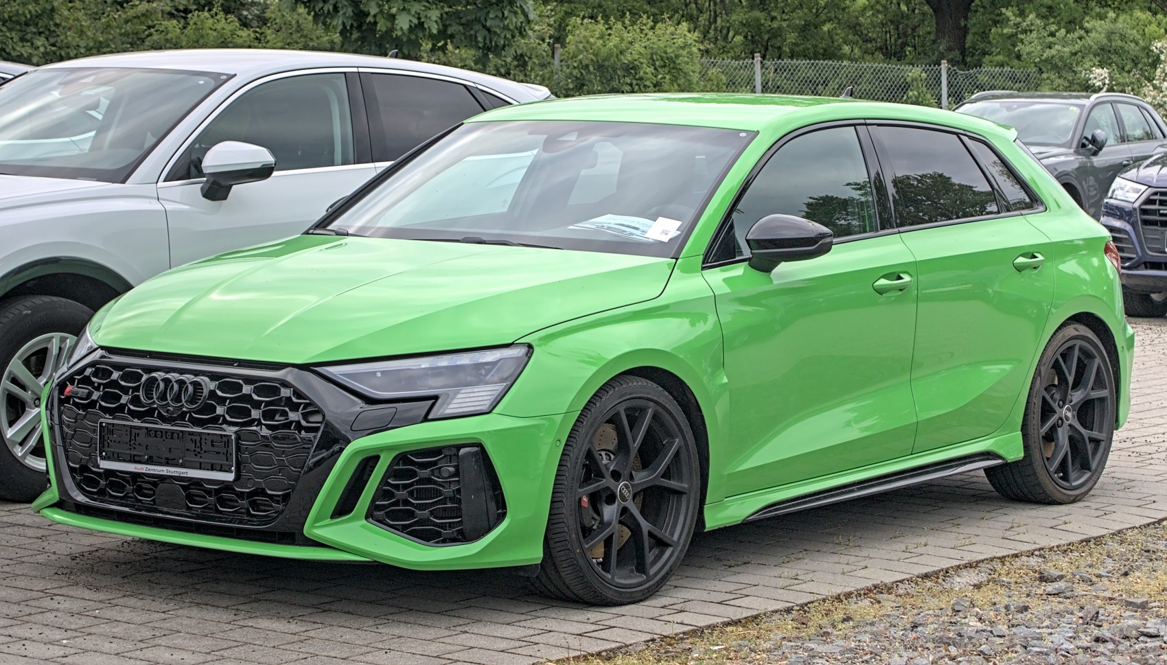 Sporty green hatchback front with black honeycomb grille and black alloy wheels