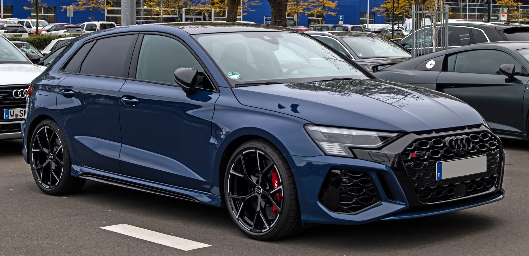 Front and side view of sporty hatchback with aggressive grille and black alloy wheels