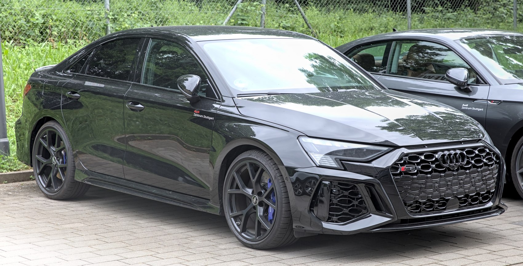 Black sedan with honeycomb grille and sporty alloy wheels