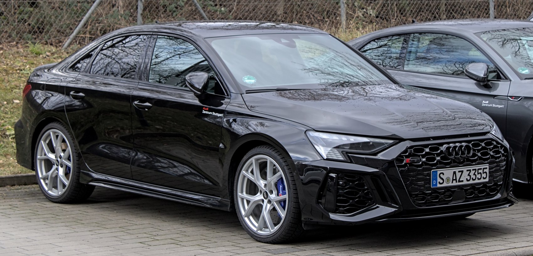 Black sedan with sporty alloy wheels and aggressive front grille