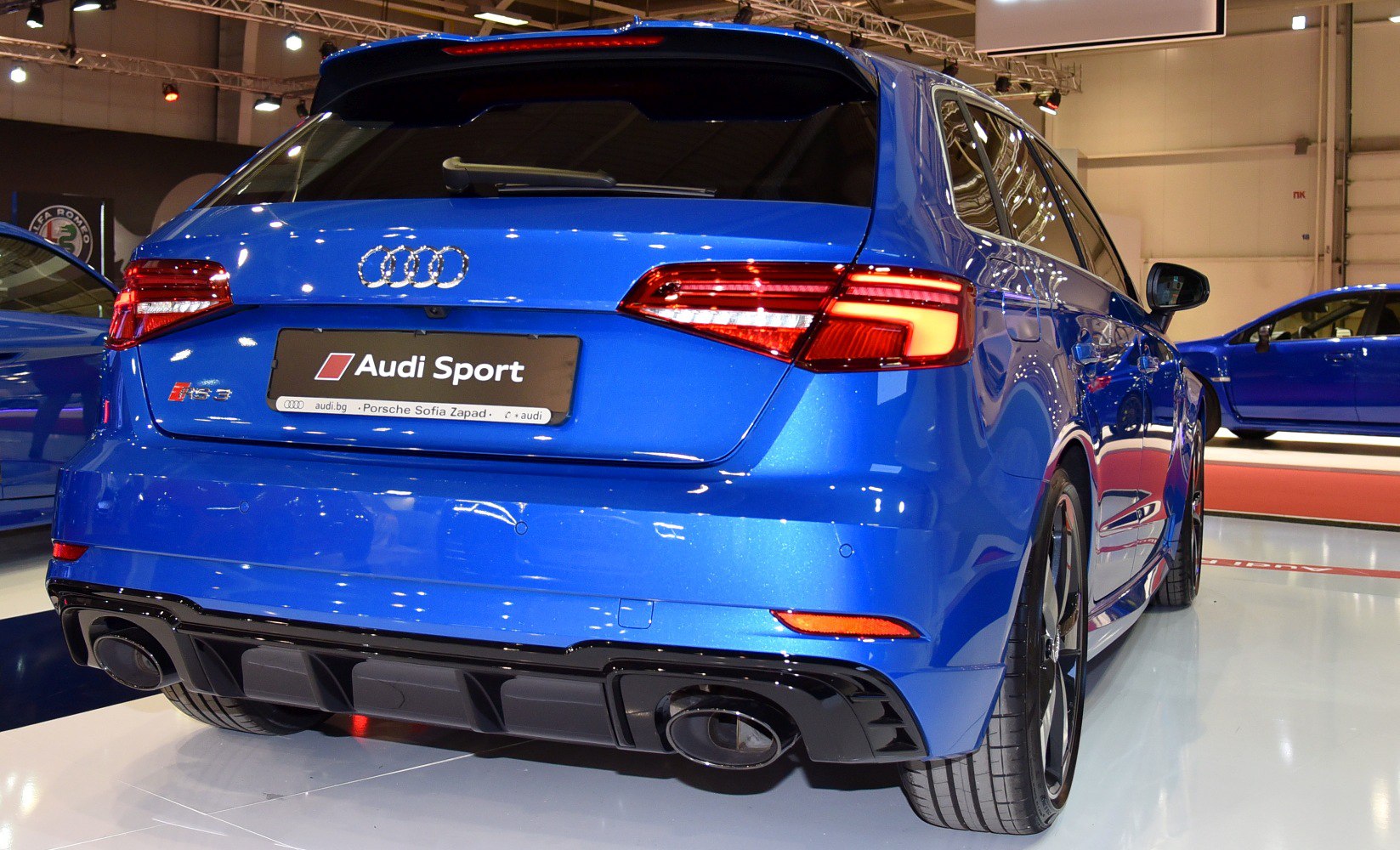 Rear view of blue hatchback with LED tail lights and black diffuser