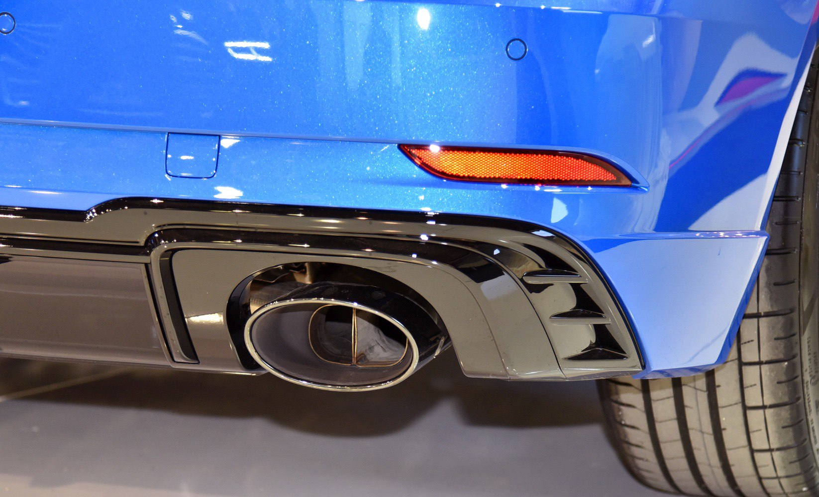 Close-up of rear exhaust tip and tire with diffuser details.