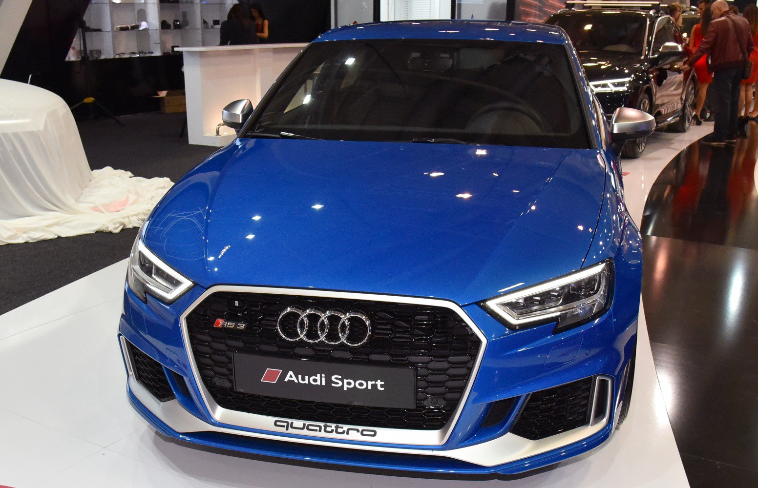 Front grille and headlights of a blue sportback car