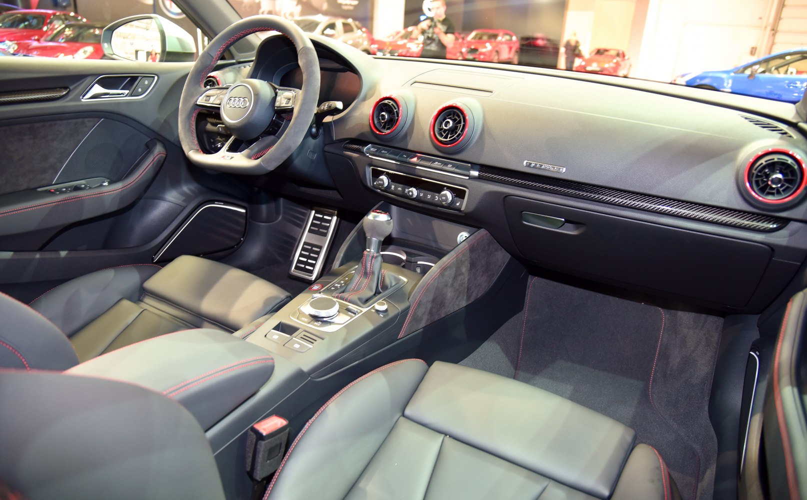 Sport steering wheel and modern dashboard with red-accented vents