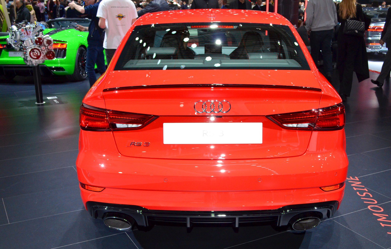 Rear view of a red sedan with sporty taillights and dual exhaust pipes