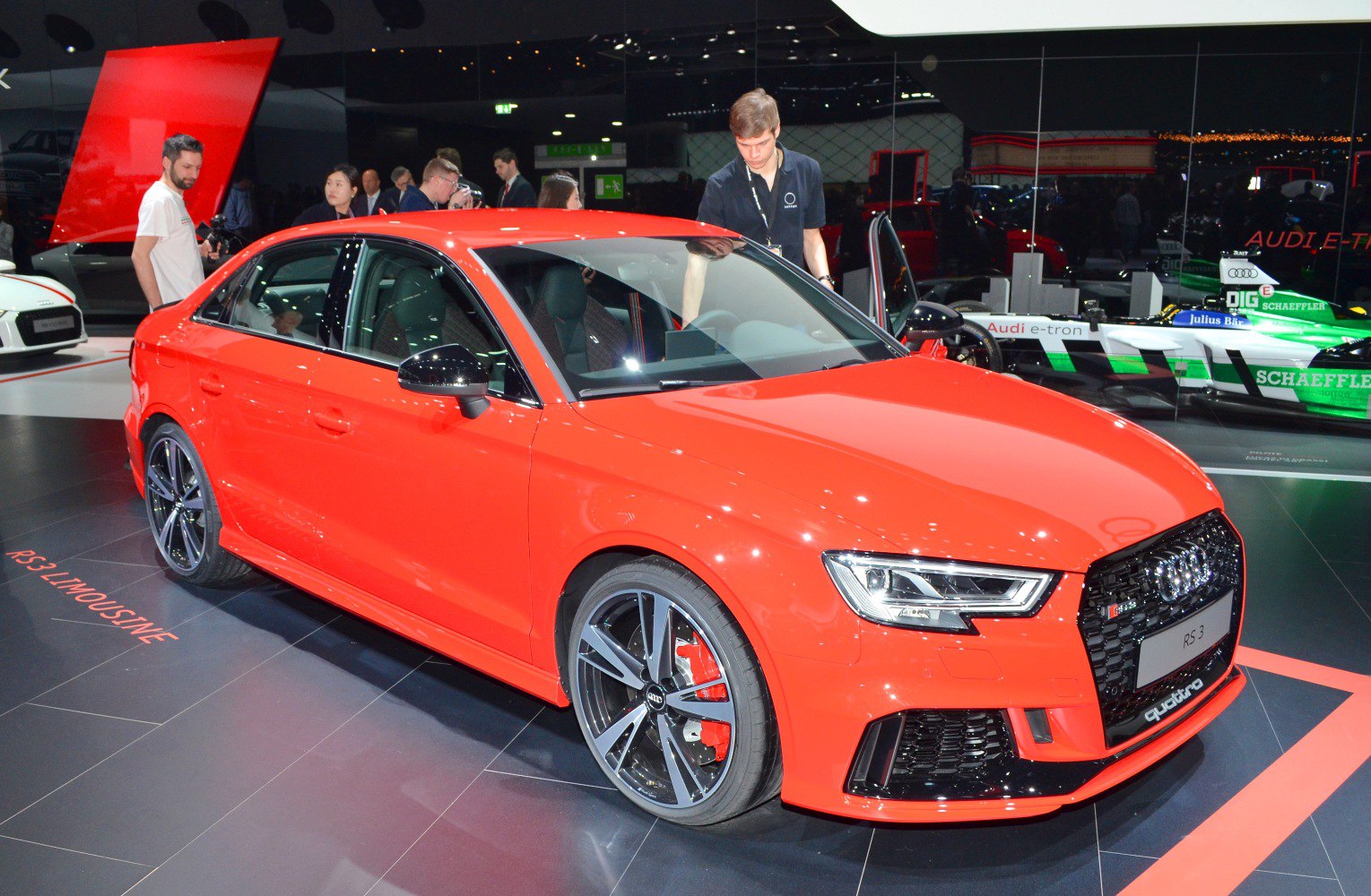 Front-side view of sporty sedan with alloy wheels and aggressive grille