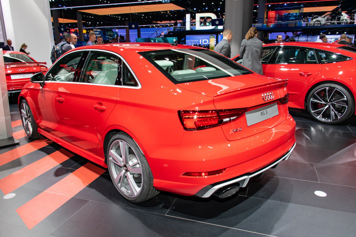 Rear view of a red sporty sedan with alloy wheels and sharp tail lights