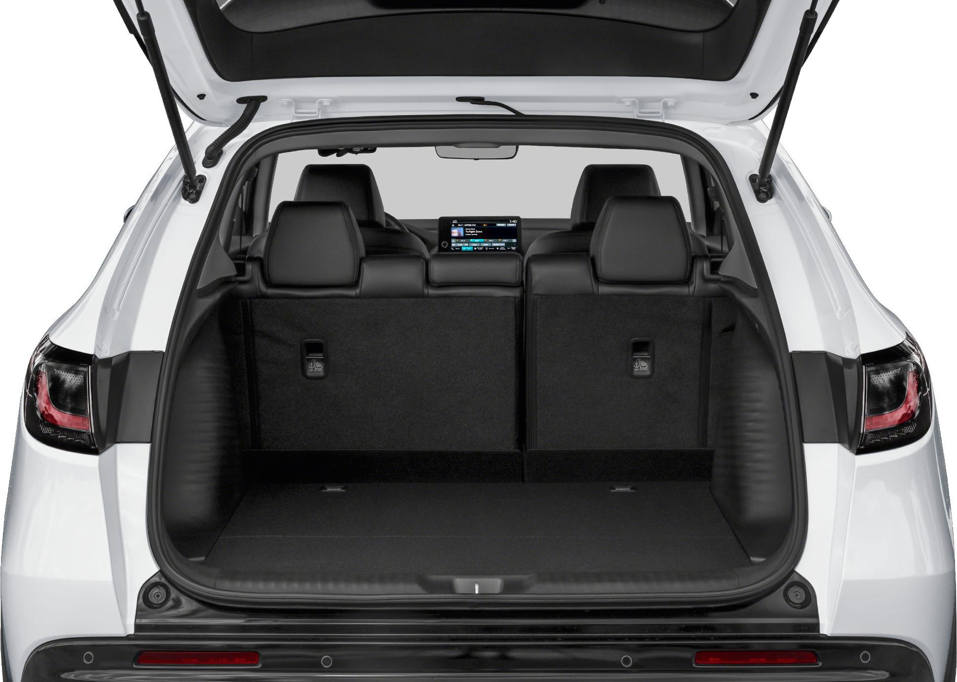 Spacious rear trunk and folded rear seats with visible infotainment screen