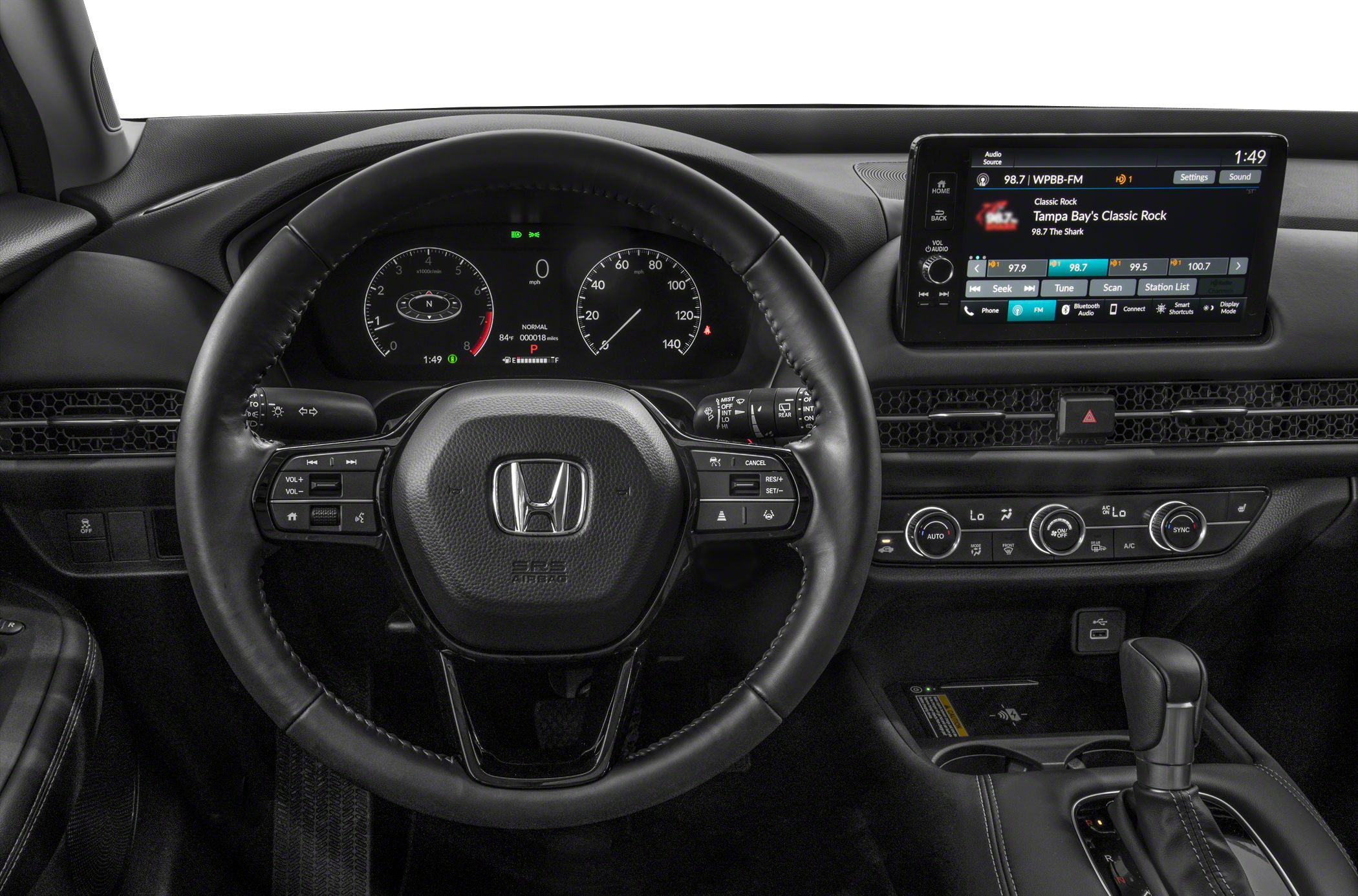 Steering wheel with controls, digital instrument cluster, infotainment touchscreen