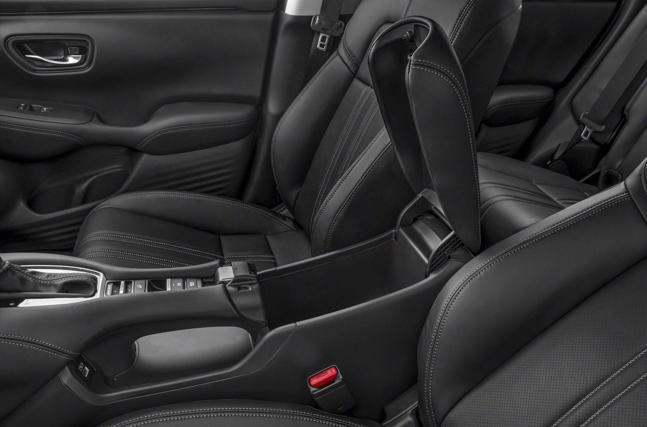 Black leather seats with detailed stitching and open center console storage