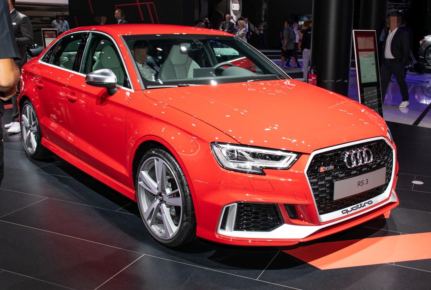 Aggressive front grille, sharp LED headlights, sporty alloy wheels, vibrant red sedan