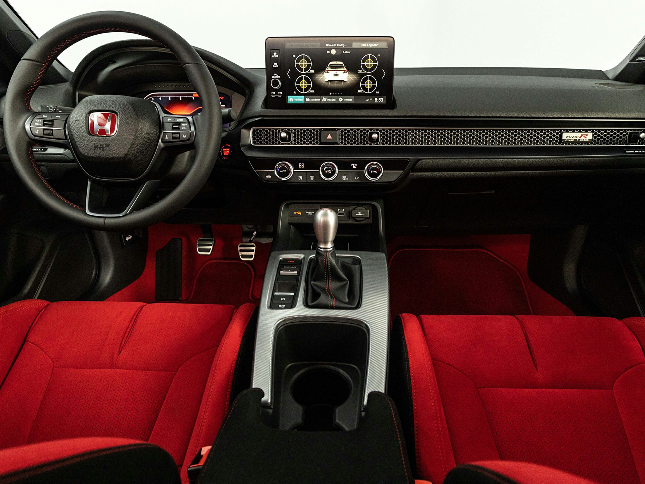 Sporty interior with red seats, digital dashboard, and manual gearshift