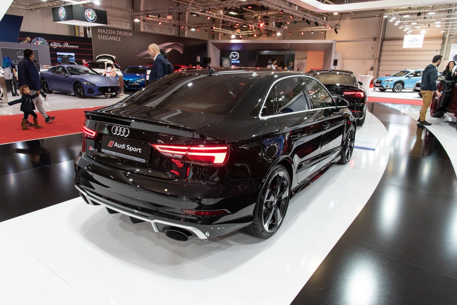 Rear view of a black sedan with LED taillights and sporty rear design