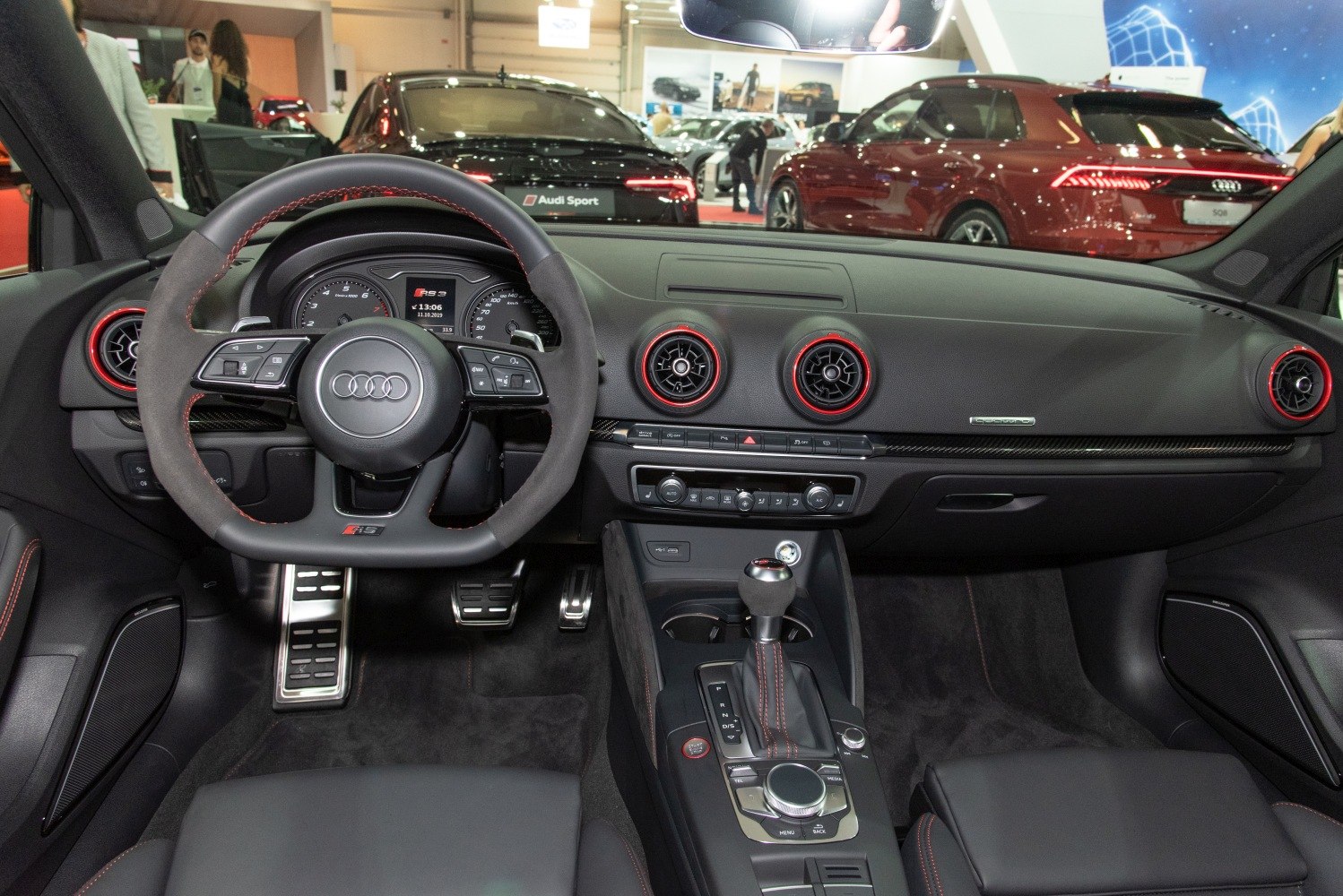 Dashboard and sporty steering wheel with red-accented air vents