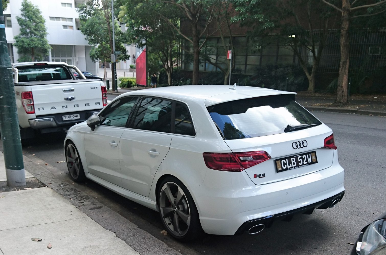 White hatchback with dual exhaust tips and sporty rear styling