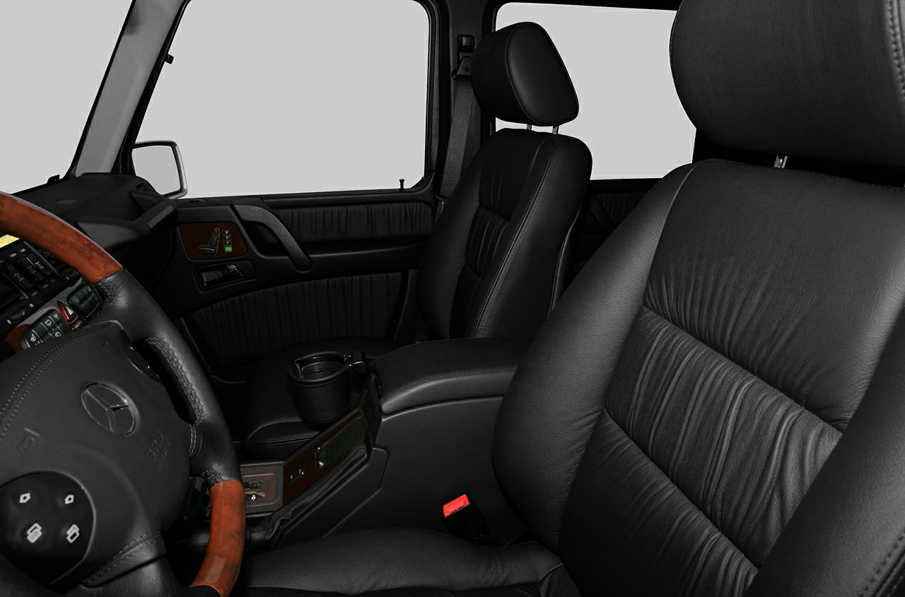 Black leather seats and wooden-accented dashboard interior