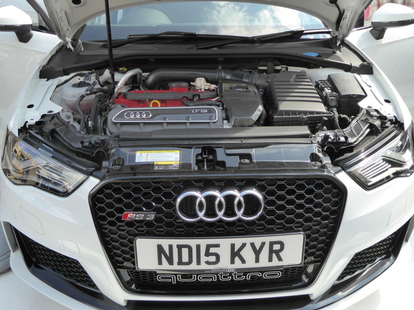 Turbocharged TFSI engine and Audi RS 3 honeycomb grille with logo