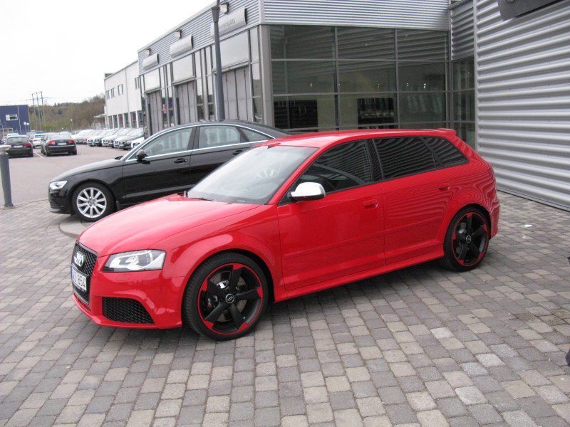Red sporty hatchback with black and red alloy wheels