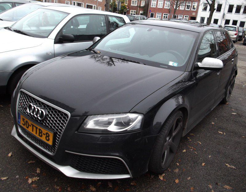 Front angled view of a sportback with honeycomb grille and silver mirror caps