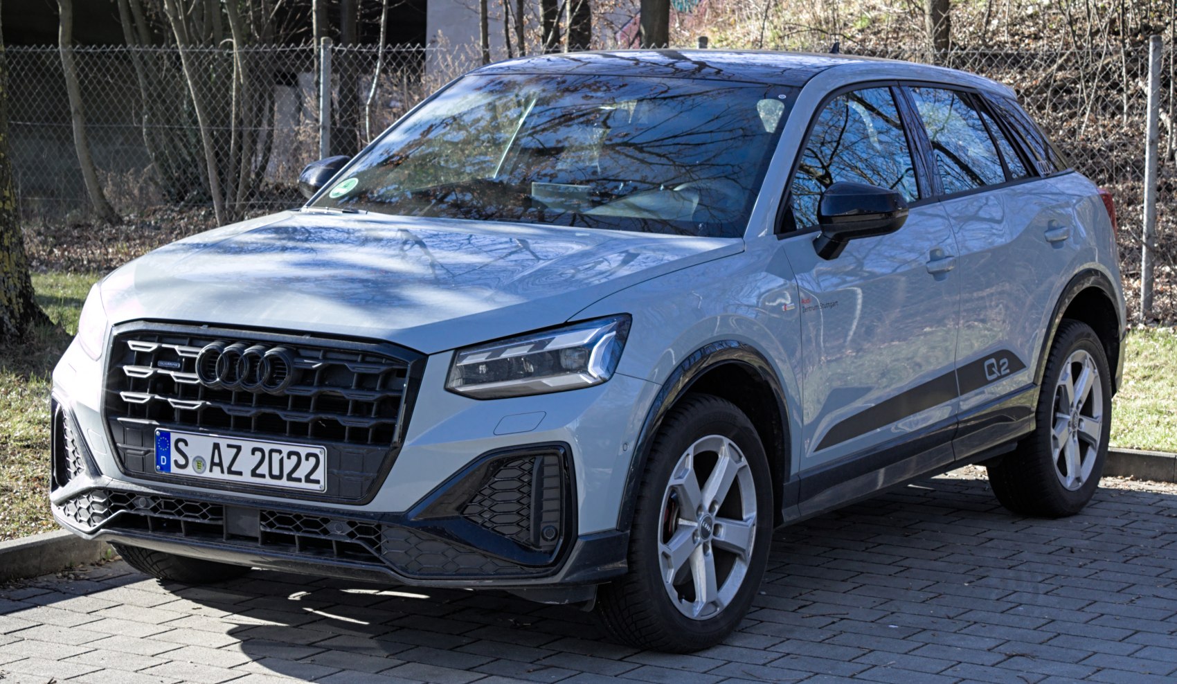 Black honeycomb grille and LED headlights on a compact SUV.
