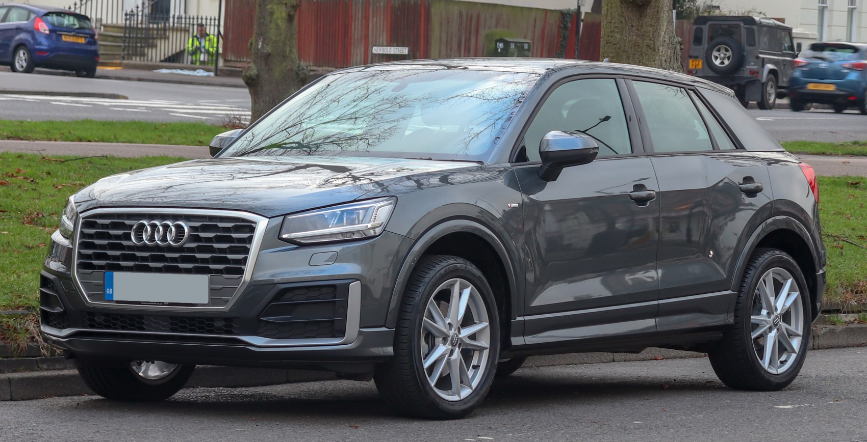Front side view showcasing LED headlights, honeycomb grille, and alloy wheels
