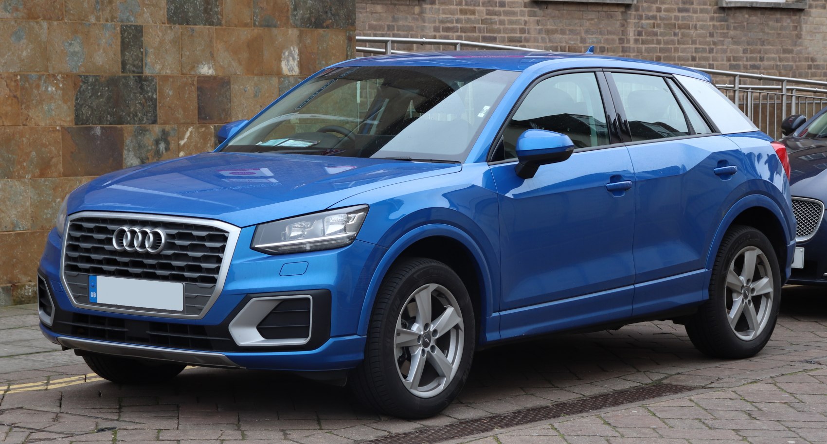 Blue compact SUV with prominent front grille and alloy wheels