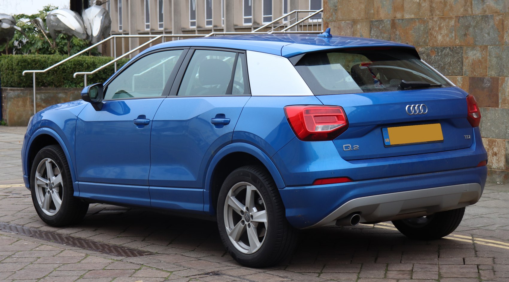 Blue SUV rear-side view with silver roof pillar and taillights