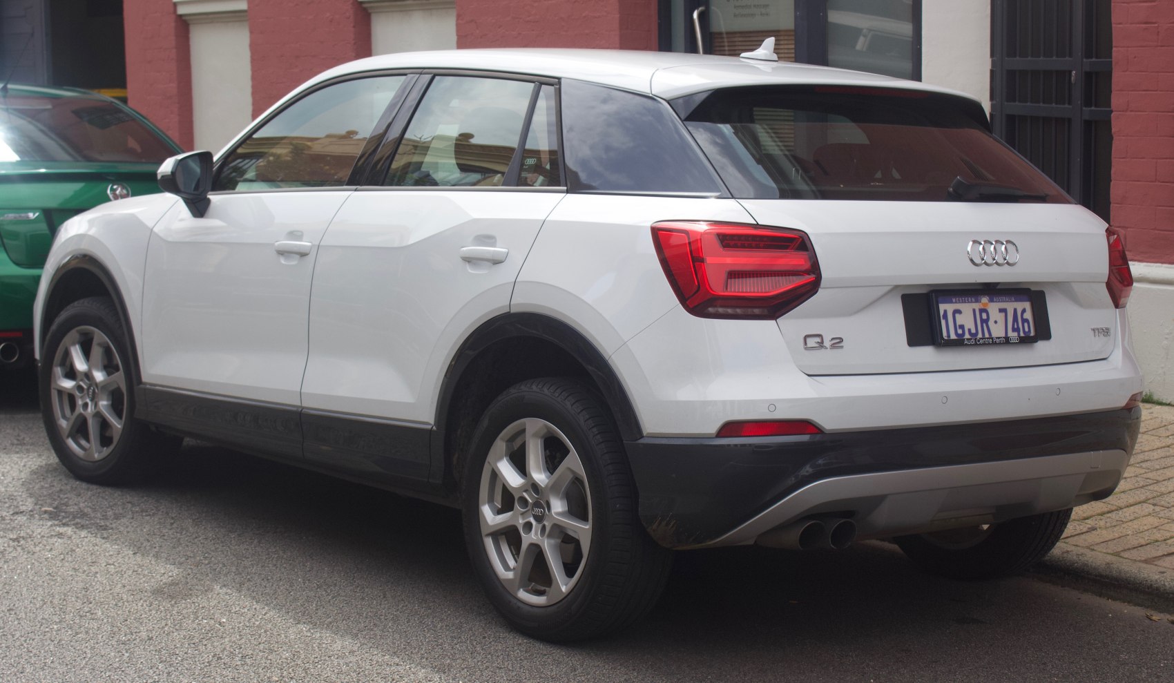 Rear-side view of white compact SUV with distinctive taillights and alloy wheels