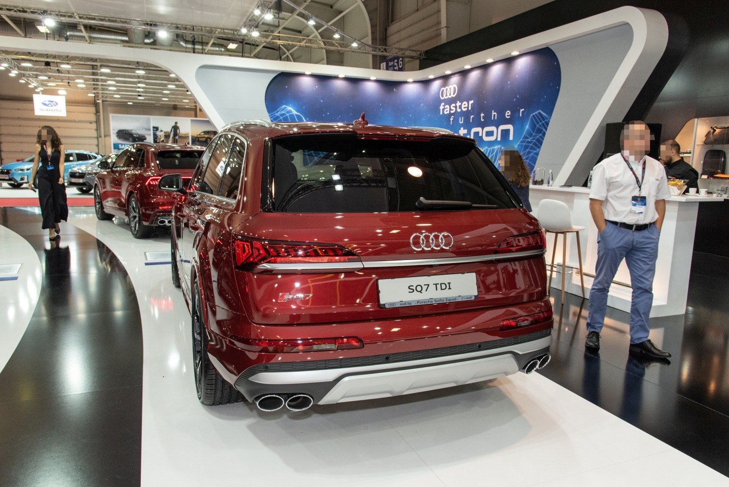 Rear view of red Audi SUV with quad exhausts and sleek LED taillights.