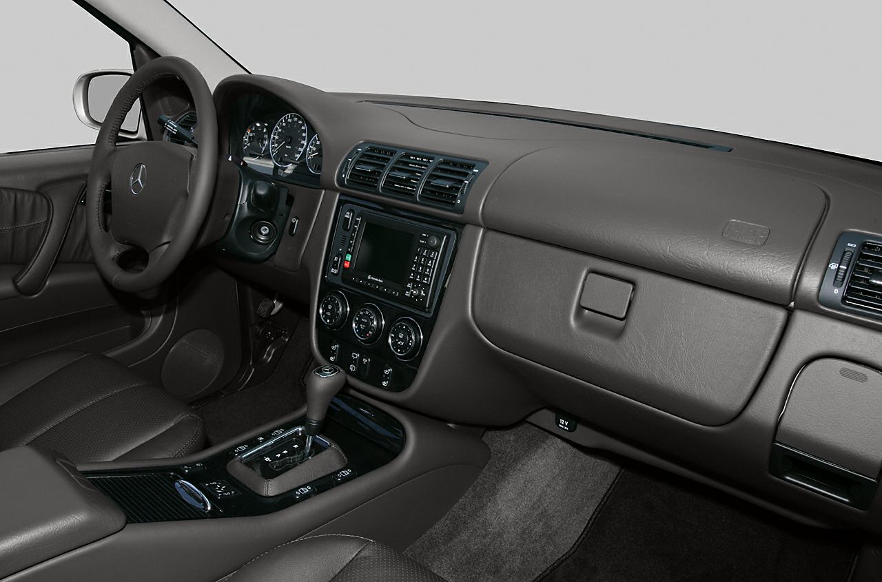 SUV interior dashboard, steering wheel, center console with gear shift