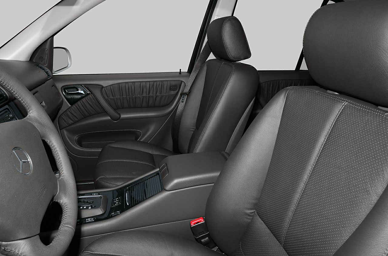 Black leather seats and dark door panel inside a luxury SUV cabin